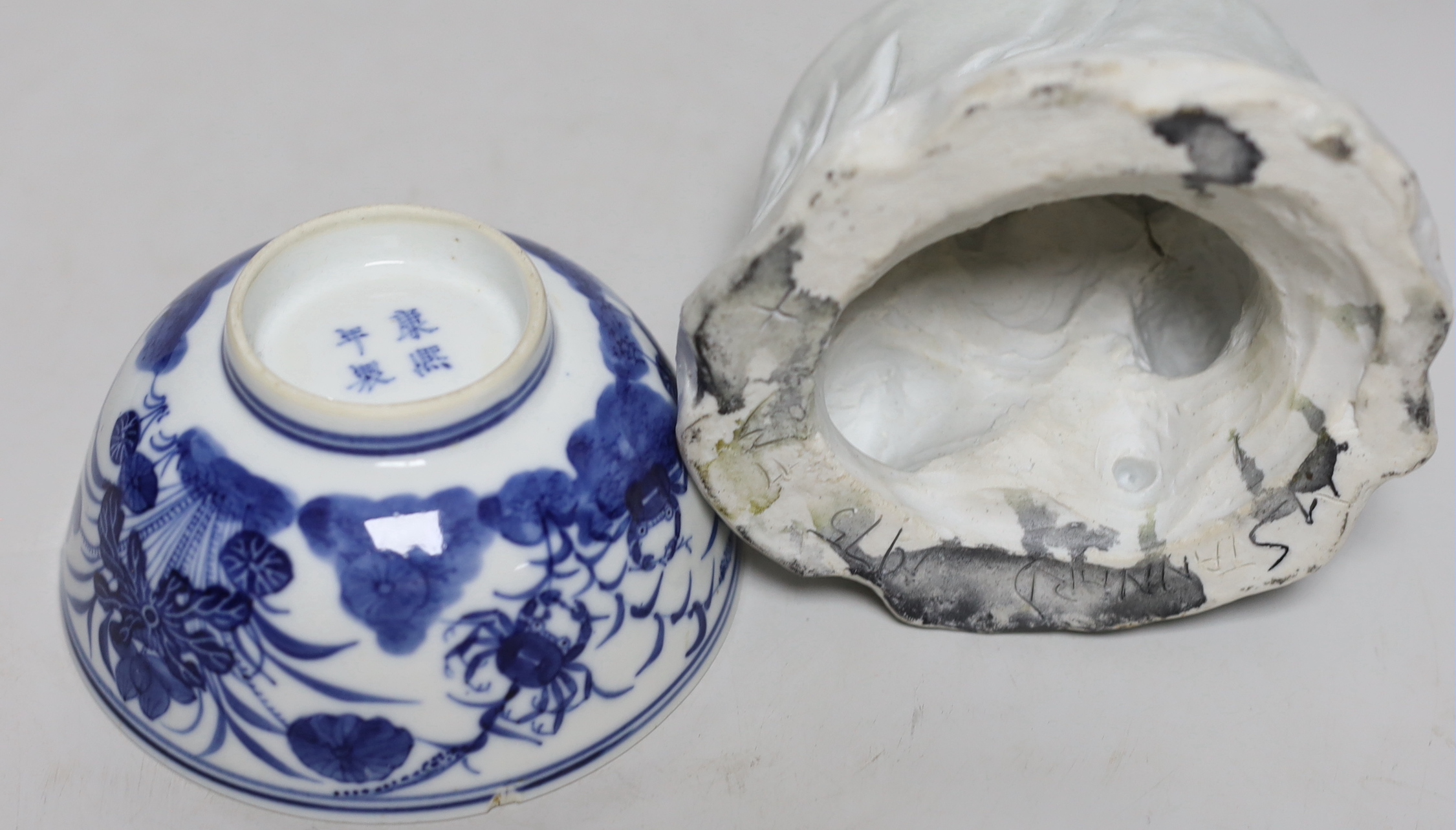 A Chinese pottery figure of a Sage, a blue and white brush pot and two bowls, sage 16cm high